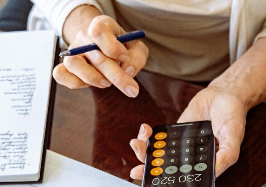 Two business professionals discussing financial documents and strategies at an office desk.
